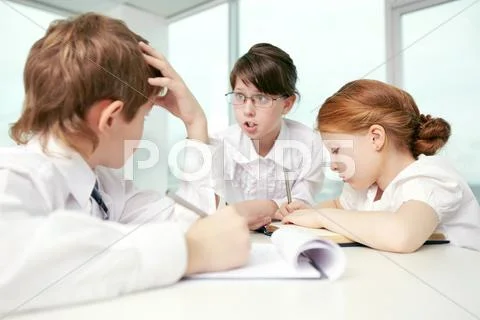 Three little children debating in classroom Stock Photos