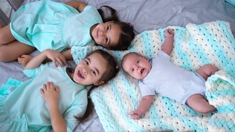 Three little kids lying in A Stock Video Pond5