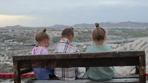 Three little sisters posing in front of balloons in Cappadocia turkey Video stock 311914767