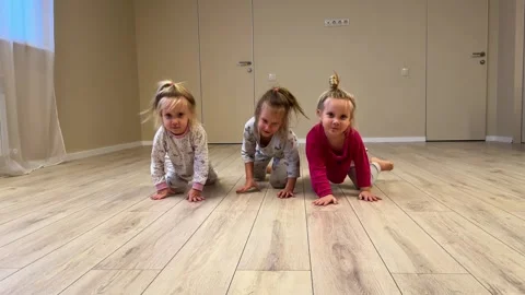 Three little sisters triplets crawl Stock Video Pond5