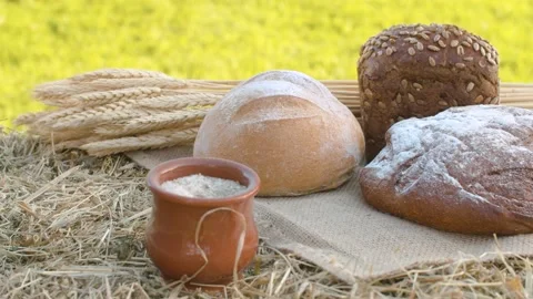 Three loafs of bread, wheat ears and clay pot Stock Footage 141600814