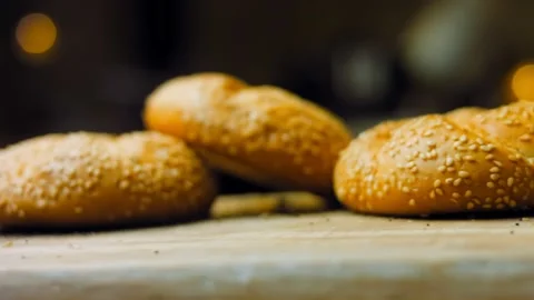 Three loaves of freshly baked bread in a round shape. In the background is a Stock Footage 197560066
