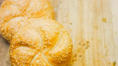 Three loaves of freshly baked bread in a round shape. In the background is a Stock Footage 197560411