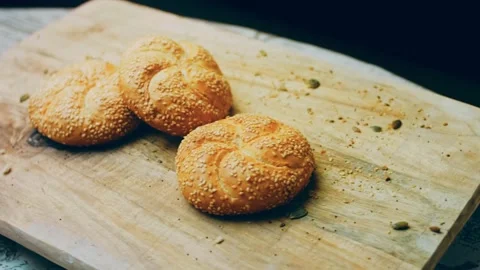 Three loaves of freshly baked bread in a round shape. In the background is a Stock Footage 231059971
