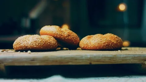 Three loaves of freshly baked bread in a round shape. In the background is a Stock Footage 231060163