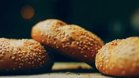 Three loaves of freshly baked bread in a round shape. In the background is a Stock Footage 231060221