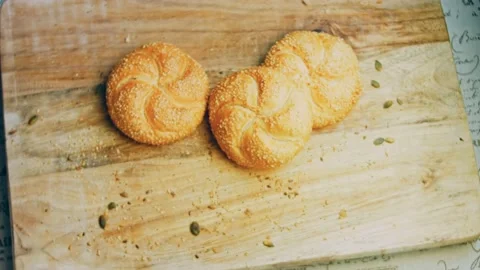 Three loaves of freshly baked bread in a round shape. In the background is a Stock Footage 231060287