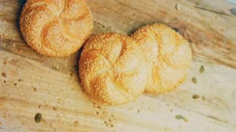 Three loaves of freshly baked bread in a round shape. In the background is a Stock Footage 231060352