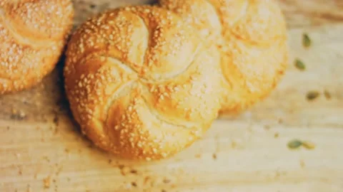 Three loaves of freshly baked bread in a round shape. In the background is a Stock Footage 231060474