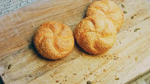 Three loaves of freshly baked bread in a round shape. In the background is a Stock Footage 231060564