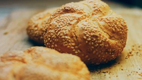 Three loaves of freshly baked bread in a round shape. In the background is a Stock Footage 231060689