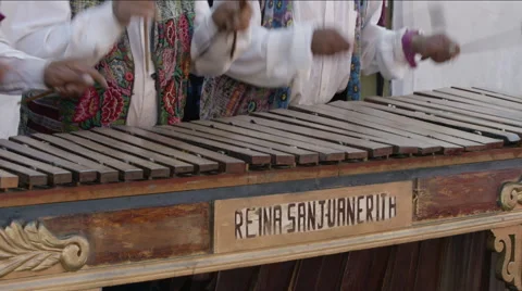 Three local musicians playing xylophone on the street of Guatemala Stock Footage 63052302