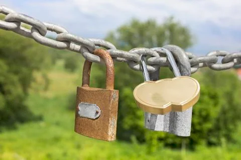 Three locks on a thick galvanized chain Foto stock