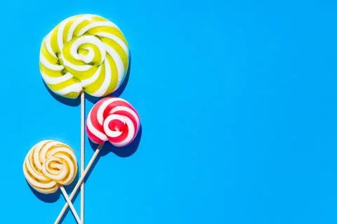 Three lolipopsweet on a blue background. Stock Photos