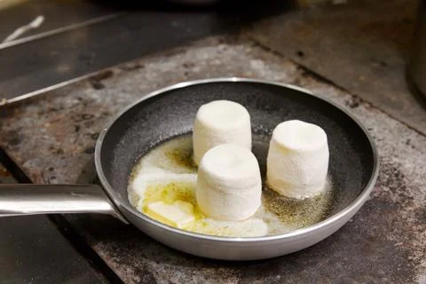 Three lush cheesecakes, fried in a pan, in butter, cooking Stock Photos