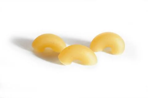 Three macaroni horns isolated on a white background. Stock Photos