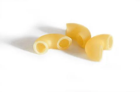 Three macaroni isolated on a white background. Macro. Stock Photos