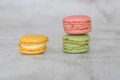 Three macarons spread in a triangular arrangement. Stock Photos