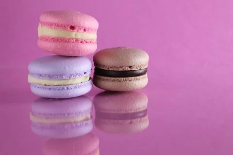 Three macaroons on a pink background. Pink macaroons on a table. Lifestyle on Stock Photos
