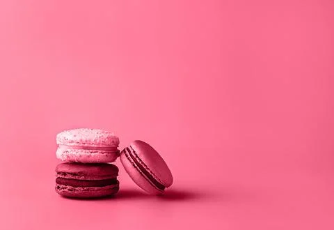 Three macaroons in stack toned in trendy magenta color of year 2023. Stock Photos