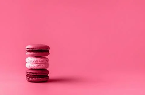 Three macaroons in stack toned in trendy magenta color of year 2023. Stock Photos