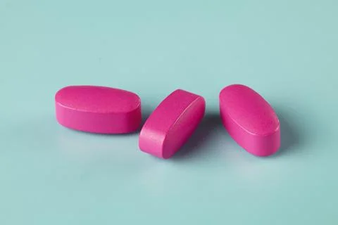 Three magenta caplets Stock Photos