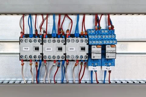 Three magnetic contactors and two intermediate relays in an electric Cabinet. Stock Photos
