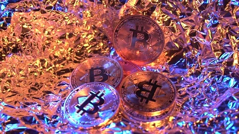 Three main crypto coins Bitcoin rotate on the gold and neon reflected surfase Video stock 134522653