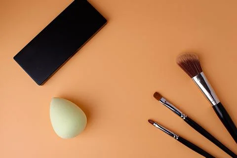 Three makeup brushes, brushes for blush, eyeshadow, lipstick,  sponge Stock Photos