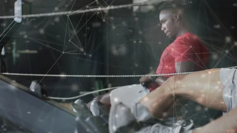 Three male athletes rowing on ergs, network overlay appearing and linking Stock Footage 333774351