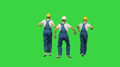 Three male construction workers in hard hats synch dancing with their backs to 스톡 동영상 138982891