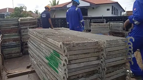 Three male workers assemble a platform on a truck Stock Footage 304337563