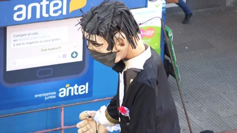 Three-man pulling the strings to move a giant puppet in the street, all Stock Footage 133578223