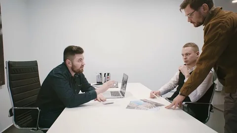 Three managers discuss the project in the office Stock Footage 82207053