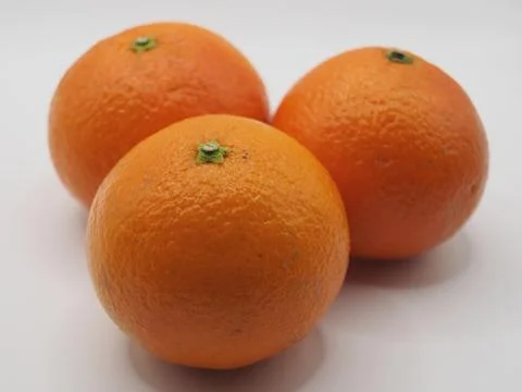Three mandarins on white background, focused on the front one. Concept: hea.. Stock Photos