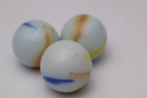 Three marble balls on a white background. Stock Photos