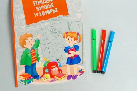 Three of the marker lying next to a notebook for school children, coloring Stock Photos