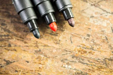 Three markers on the old table Stock Photos