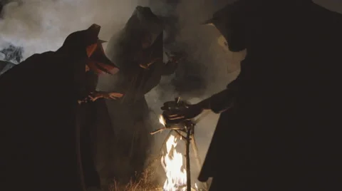 Three masked withes and their pot on the fire Видео 59345625
