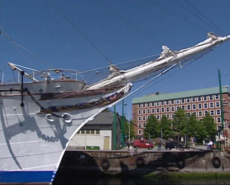 Three-masted barque Statsraad Lehmkuhl moored in Bergen Havn - pan + tilt Stock Footage 35283899