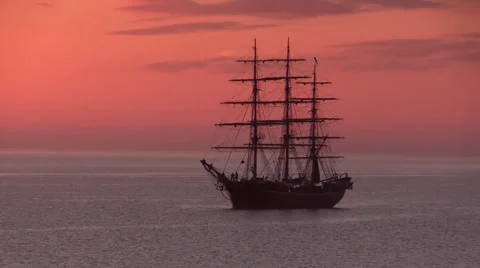 Three-masted full-rigged tall ship in beautiful reddish sunrise Video stock 37114663