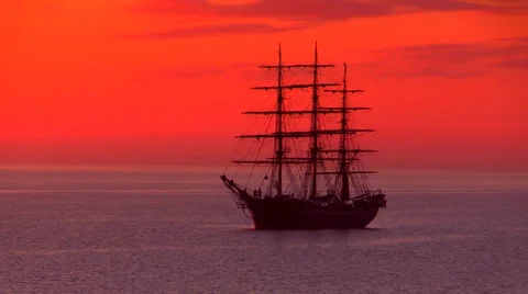 Three-masted full-rigged tall ship in beautiful reddish sunrise Видео 37137899