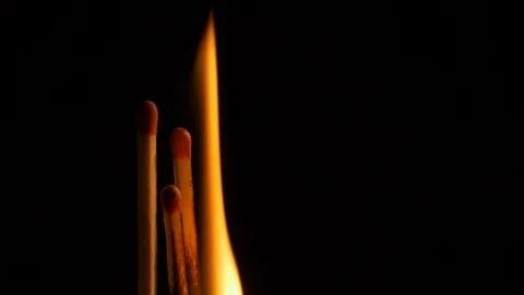 Three matches lighting and burning. Black background Stock Footage 126624494