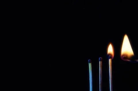 Three matches vertically in the lower right corner against a dark background  Stock Photos