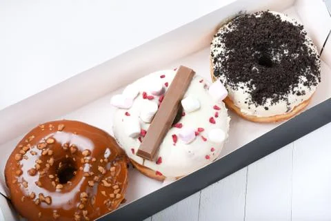 Three melted glazed with dark and white chocolate, marshmallows, biscuit crum Stock-Fotos