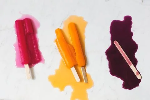 Three melted popcicles Stock Photos