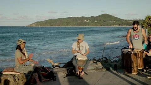 Three members of an african drum group at main beach in byron bay Stock Footage 165958631