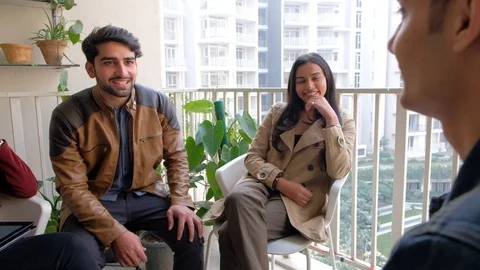 Three members of a team interview a possible new recruits in the outdoor relaxed Stock Footage 101182412