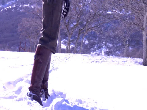 Three members were chasing one by one in the snow area Stock Footage 23103061