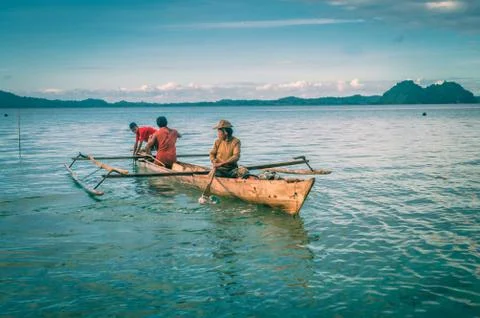 Three men in boat Stock Photos